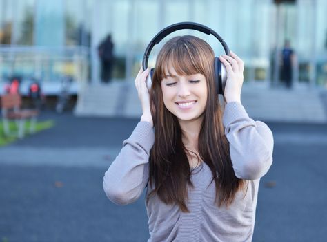 Beautiful girl in headphones over white background