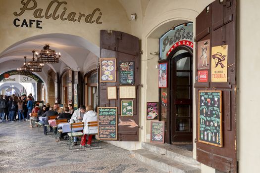 PRAGUE, CZECH REPUBLIC - MARCH 13th, 2014 - Prague shops and restaurants situated in historic center Little Quarter with relaxing tourists.