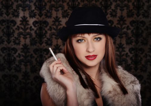 Beautiful woman in retro style over dark vintage background