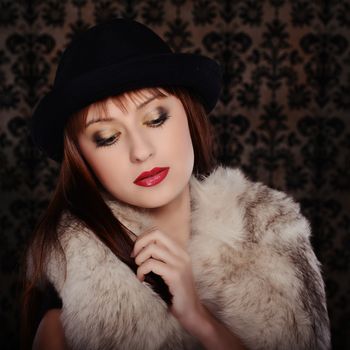 Beautiful woman in retro style over dark vintage background
