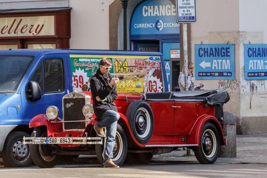 PRAGUE, CZECH REPUBLIC - MARCH 13th, 2014 - Famous historic red car Praga in Prague street. Praga is a manufacturing company founded in 1907 based in Prague, Czech Republic.