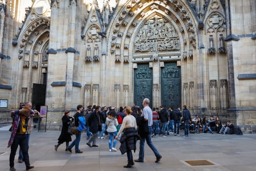 PRAGUE - MARCH 13: Tourist at Saint Vitus Cathedral on March 13, 2014 in Prague. This cathedral is an excellent example of Gothic architecture, the biggest and most important church in the country 