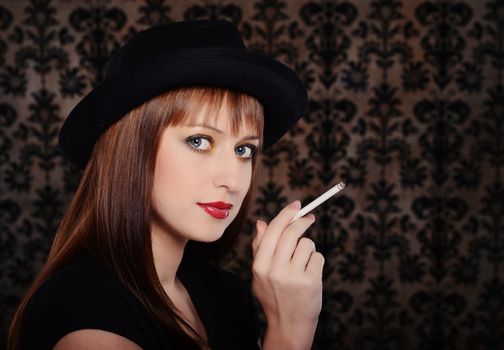 Beautiful woman in retro style over dark vintage background