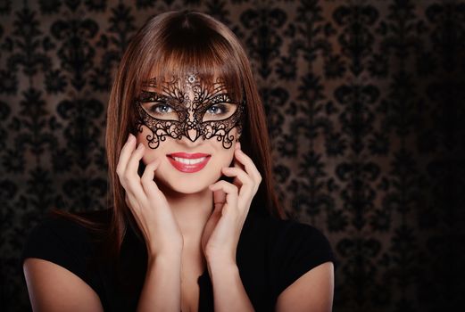Beautiful woman in retro style over dark vintage background