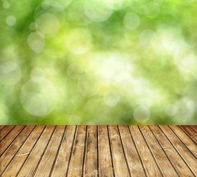 Empty wooden table and spring defocused background