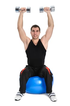young man doing dumbbells exercise on medicine ball