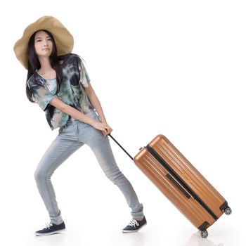Exciting Asian woman drag a luggage, full length portrait isolated on white background.