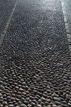 Rolling stones pavement soil texture in Altea Alicante mediterranean village of Spain