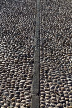Rolling stones pavement soil texture in Altea Alicante mediterranean village of Spain