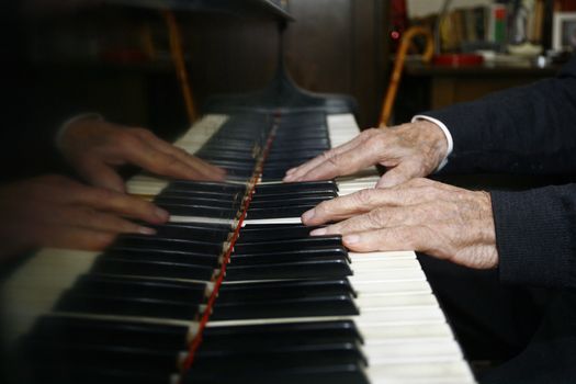Male hands playing the piano
