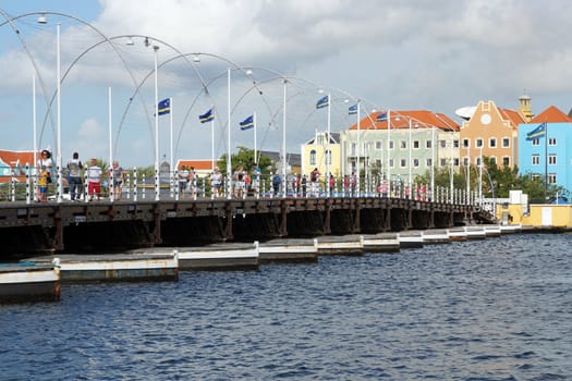 WILLEMSTAD, CURACAO - DECEMBER 10, 2013: Historic Queen Emma Bridge on December 10, 2013 in Willemstad, Curacao, ABC Islands. The Bridge is the landmark of Willemstad.