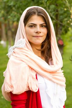 Beautiful middle eastern woman in pink scarf.