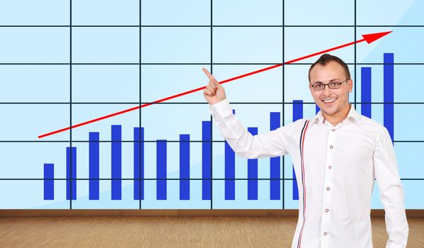 happy man pointing at graph on plasma wall