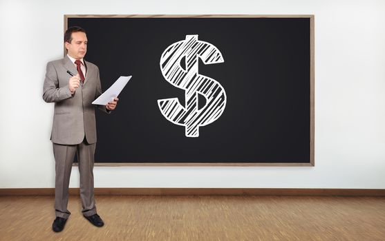 businessman standing in office and dollar on blackboard