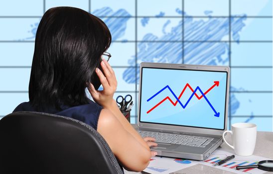 woman and chart on screen laptop sitting in office