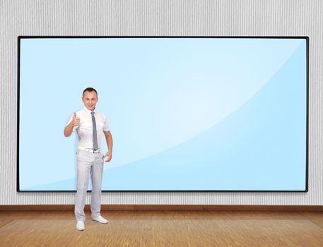 Young businessman showing thumb up and smile