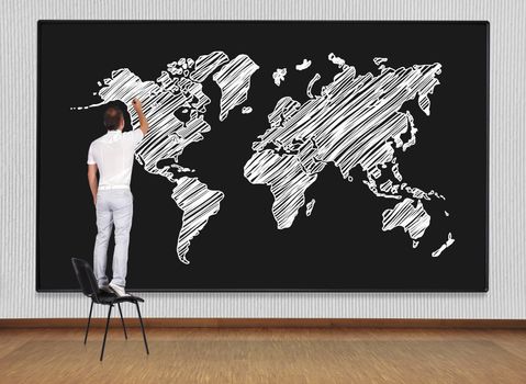 man standing on chair and drawing world map