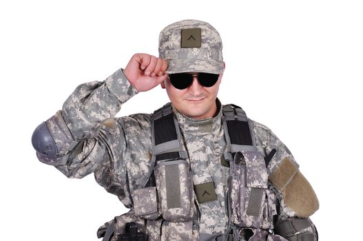 US soldier adjusts his cap on white background