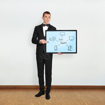 businessman in room holding plasma with computer network