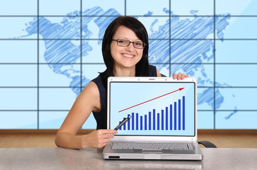 woman sitting in office and laptop with chart