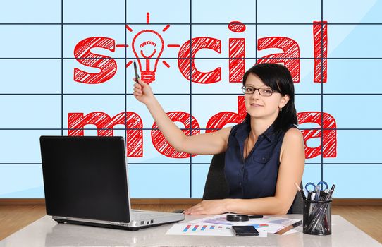 woman in office pointing at plasma panel with social media