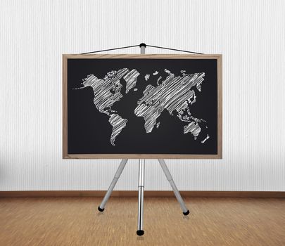 blackboard with drawing world map on tripod standing in office