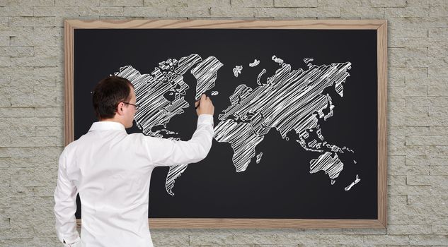 young businessman drawing world map  on blackboard