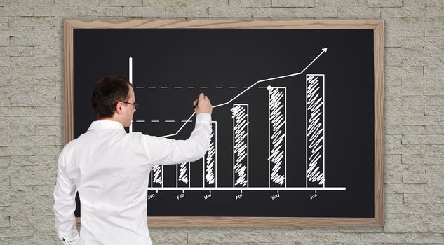 businessman drawing graph on blackboard