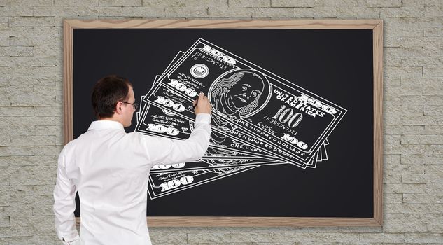 young businessman drawing dollars on  blackboard