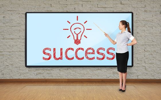 businesswoman in office pointing at plasma with success