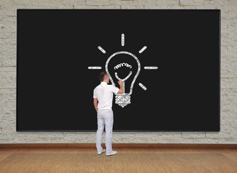 man standing and drawing lamp