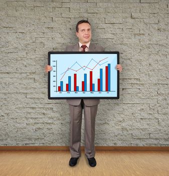 businessman in room holding plasma with graph