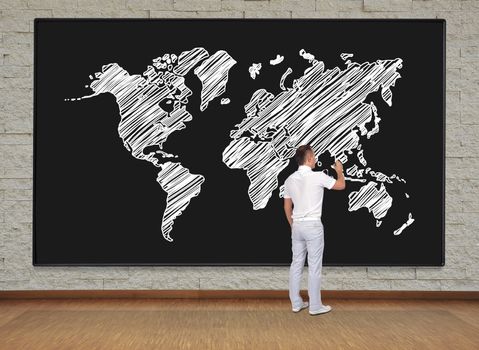 man standing and drawing world map