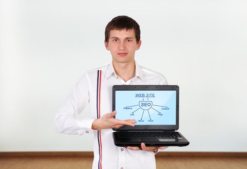 boy holding laptop with seo scheme on screen