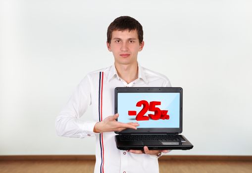 boy holding laptop with discount on screen