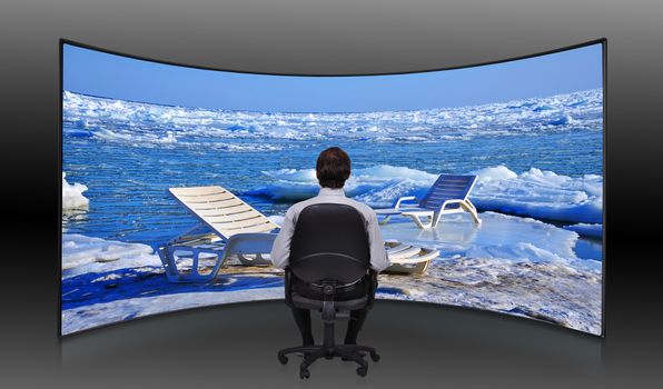 businessman sitting in movie house and looking at  frozen sea