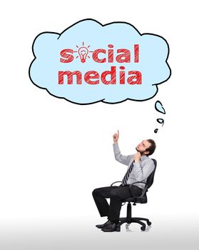 businessman sitting in chair and pointing to cloud with social media