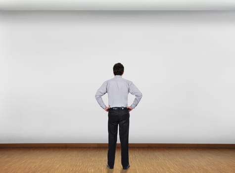 businessman in office looking at blank wall