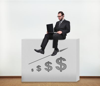 businessman sitting on concrete wall with graphic