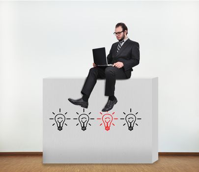 businessman sitting on concrete wall with idea concept