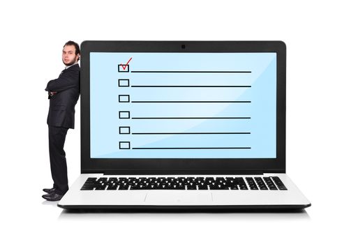 Businessman leaning on a laptop with check box