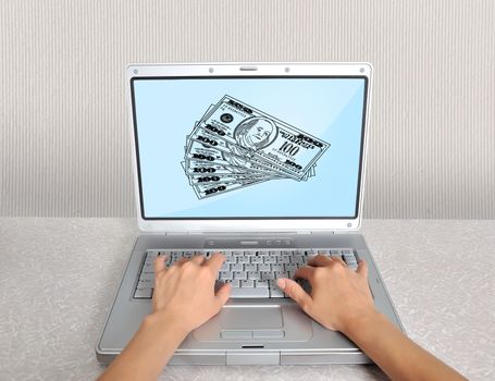 hands and laptop with money on the table