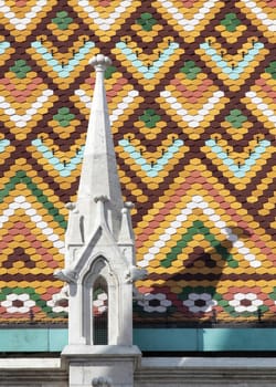 Close-up of ornate temple roofs and small towers.