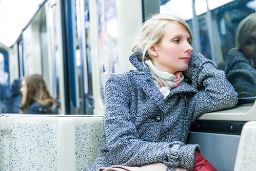 Young Woman Using Environmental Public Transportation to go Back Home After Work