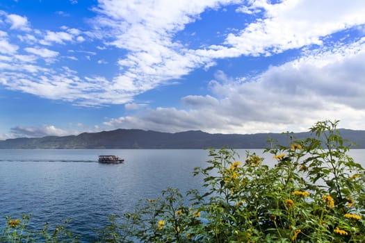 Flowers and Boat on Lake Toba. Samosir Island North Sumatra, Indonesia.