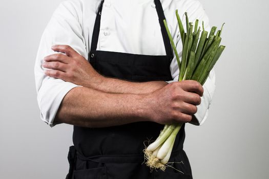 chef holding spring onions