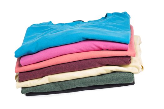 Multicolored clothing  in pile on the light background