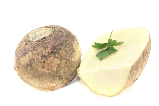 two rutabaga with parsley on a bright background