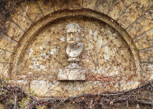 Eroded stone sculpture memorial grave at the cemetery.