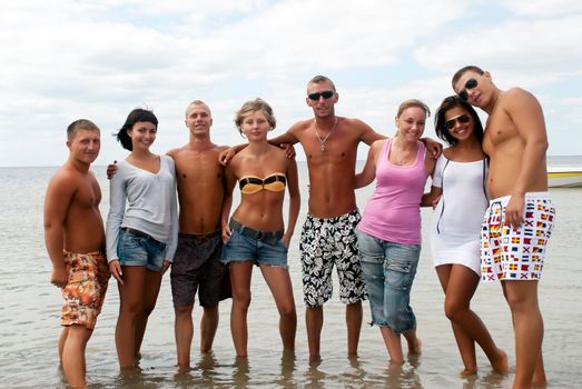 Group of friends having fun at the sea